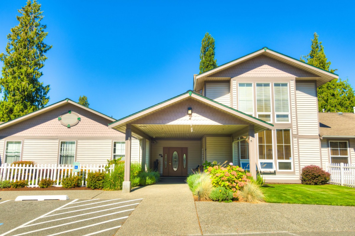 A suburban residential building with a welcoming entrance and well-maintained front yard.