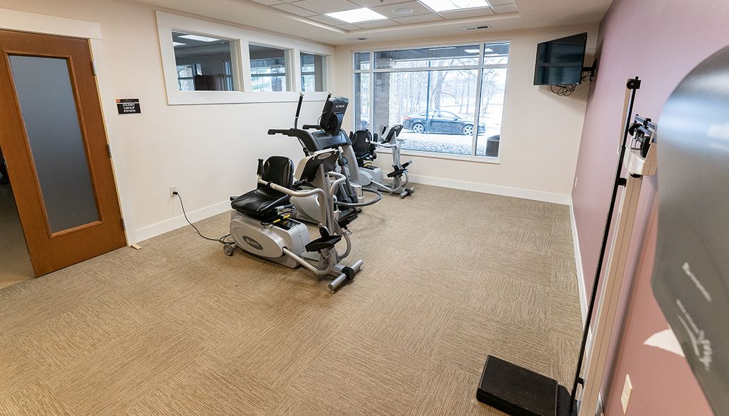 An indoor gym with exercise equipment and cardio machines.