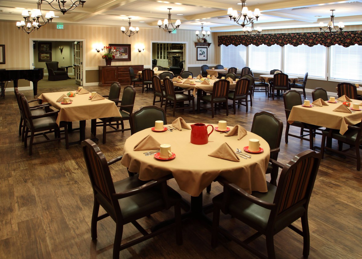 A well-arranged restaurant dining area with neatly set tables and chairs.