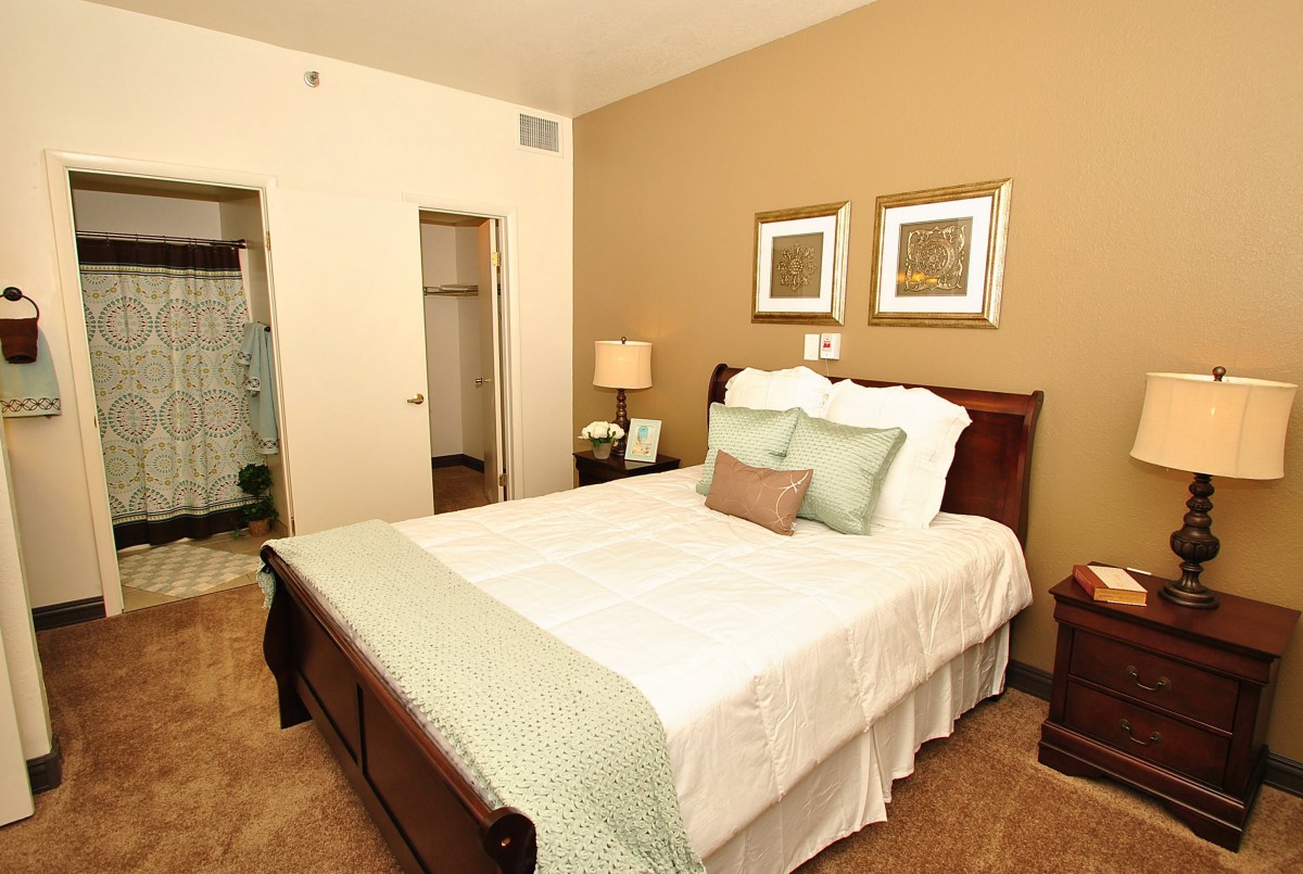 A cozy bedroom with a neatly made bed and tasteful decor.