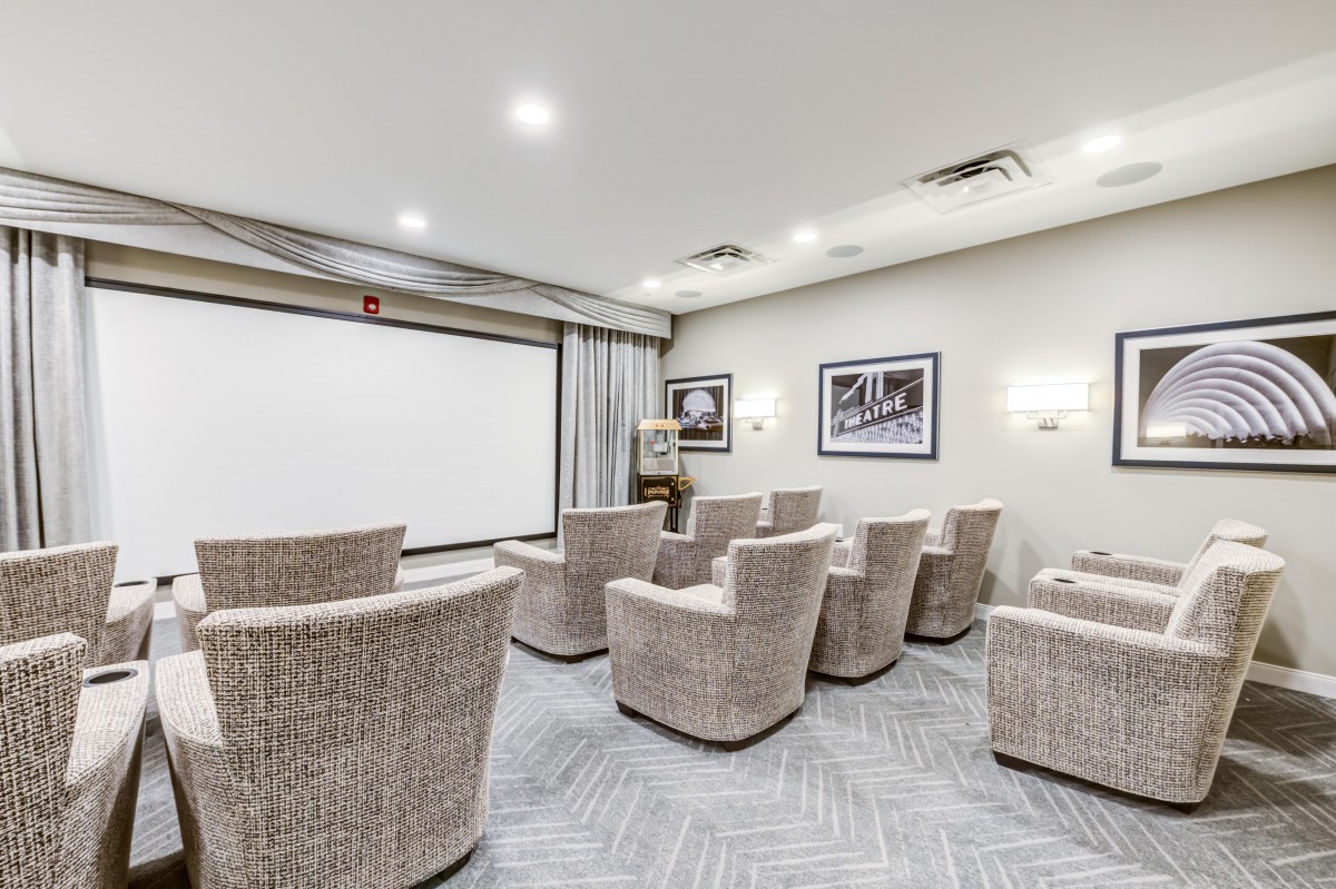 A modern home theater with comfortable seating and a large screen.