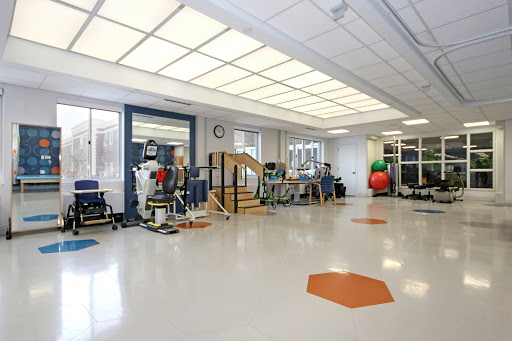 A spacious and well-equipped physical therapy room designed for rehabilitation exercises.