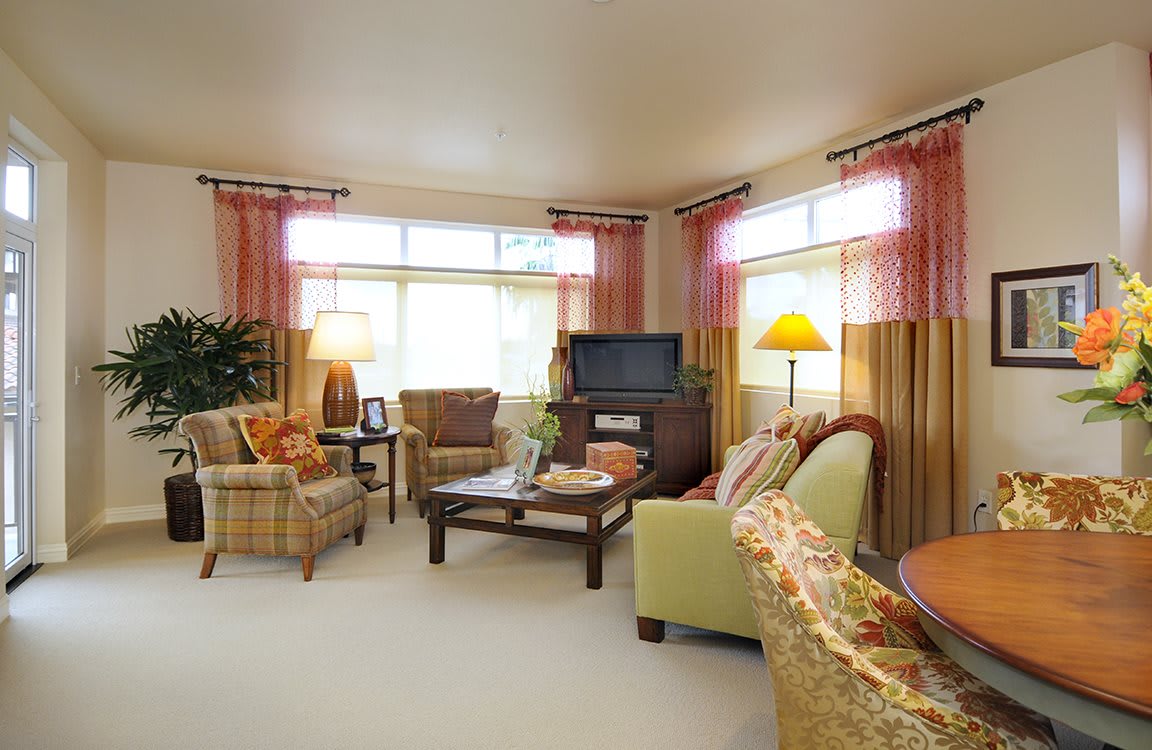 A cozy living room with a mix of comfortable seating, warm lighting, and stylish decor.