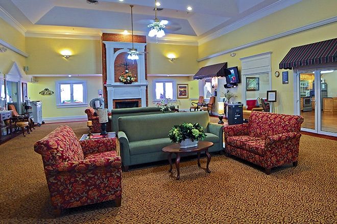 A cozy living room with colorful furniture and warm lighting.