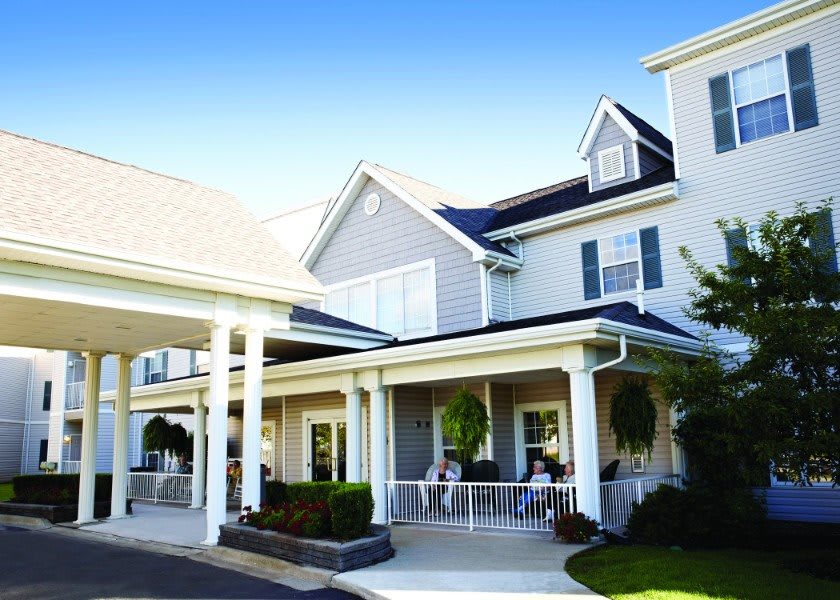 A beautiful residential building with a spacious porch and elegant design.