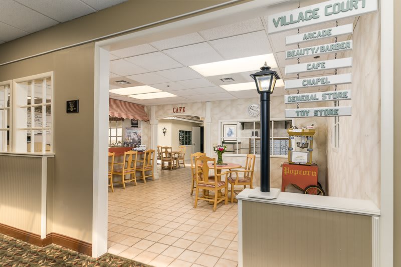 An inviting cafe interior with wooden tables and chairs, welcoming guests to dine.
