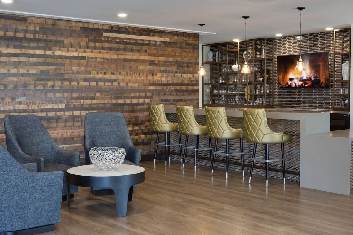 A modern bar interior with wooden accents and stylish seating.