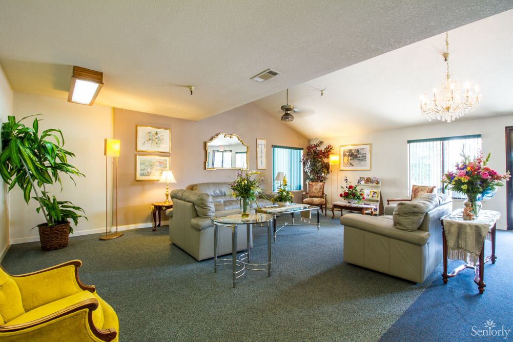 A spacious living room featuring comfortable sofas, a coffee table, and elegant decor.