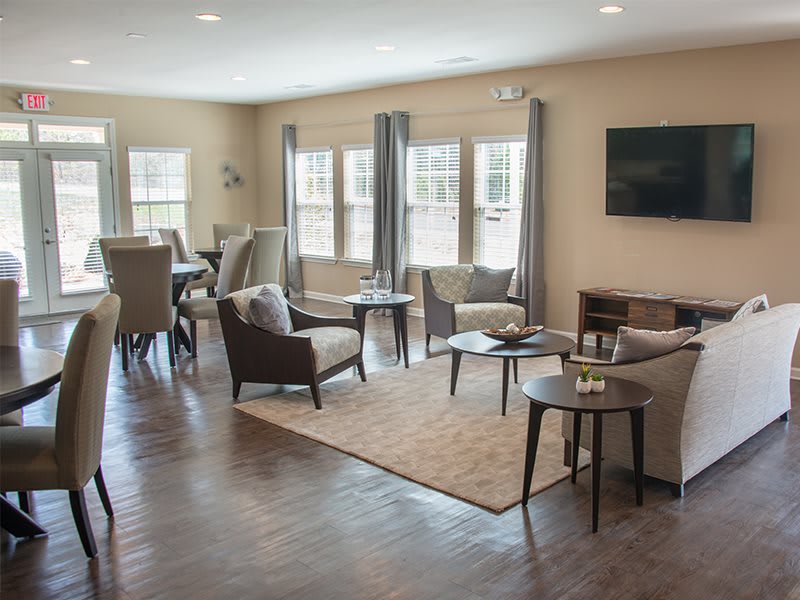 A modern living room with a cozy seating arrangement and adjacent dining area.