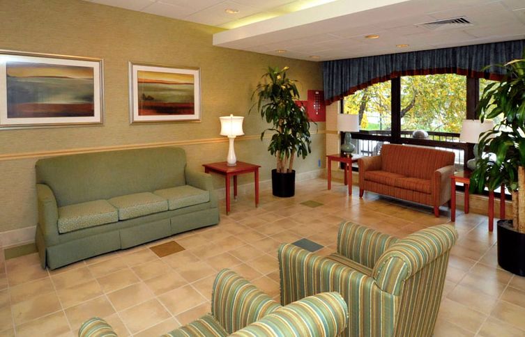 A cozy hotel lobby featuring comfortable seating and decorative elements.