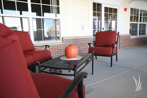 A cozy outdoor seating area adorned with a pumpkin, perfect for autumn gatherings.