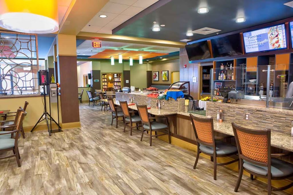 A modern restaurant interior with a bar and ample seating.