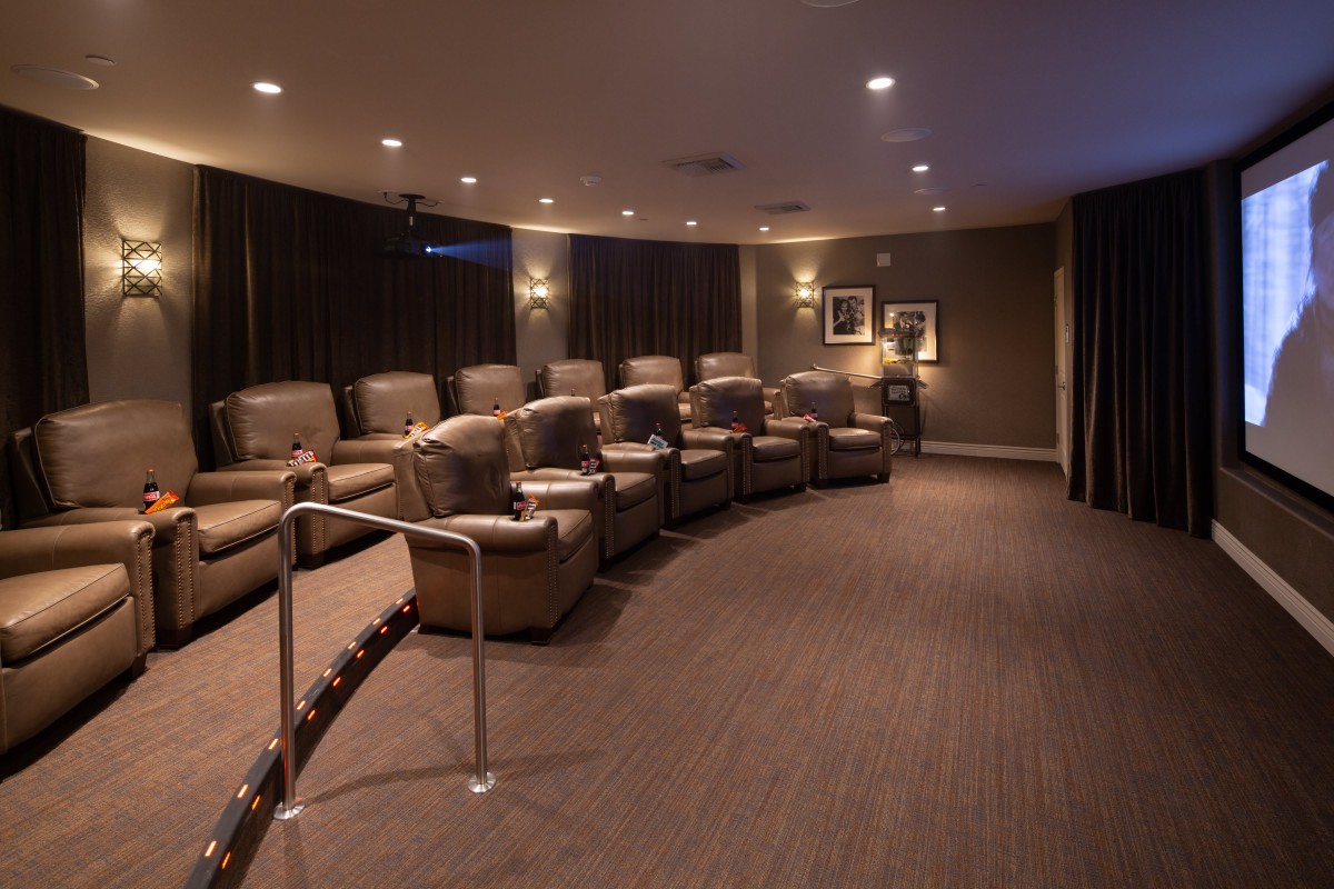 A luxurious home theater with comfortable recliner seating.