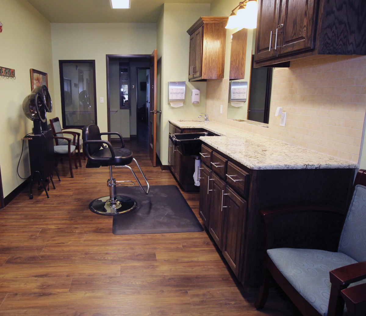 A modern salon interior with styling chairs, mirrors, and wooden flooring.