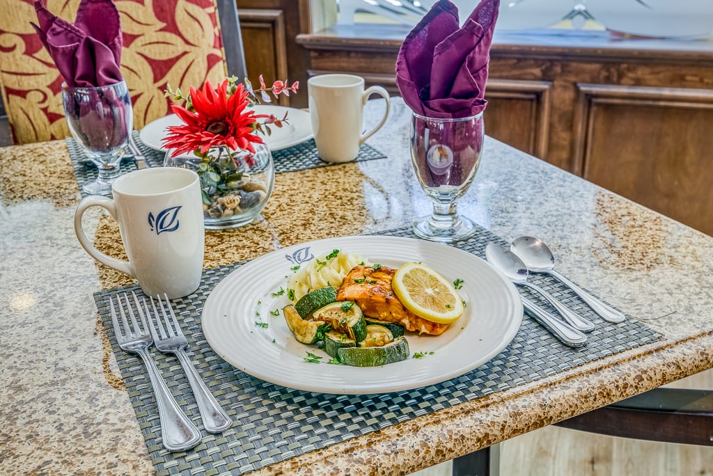 A beautifully set dining table with a plated meal and elegant decor.