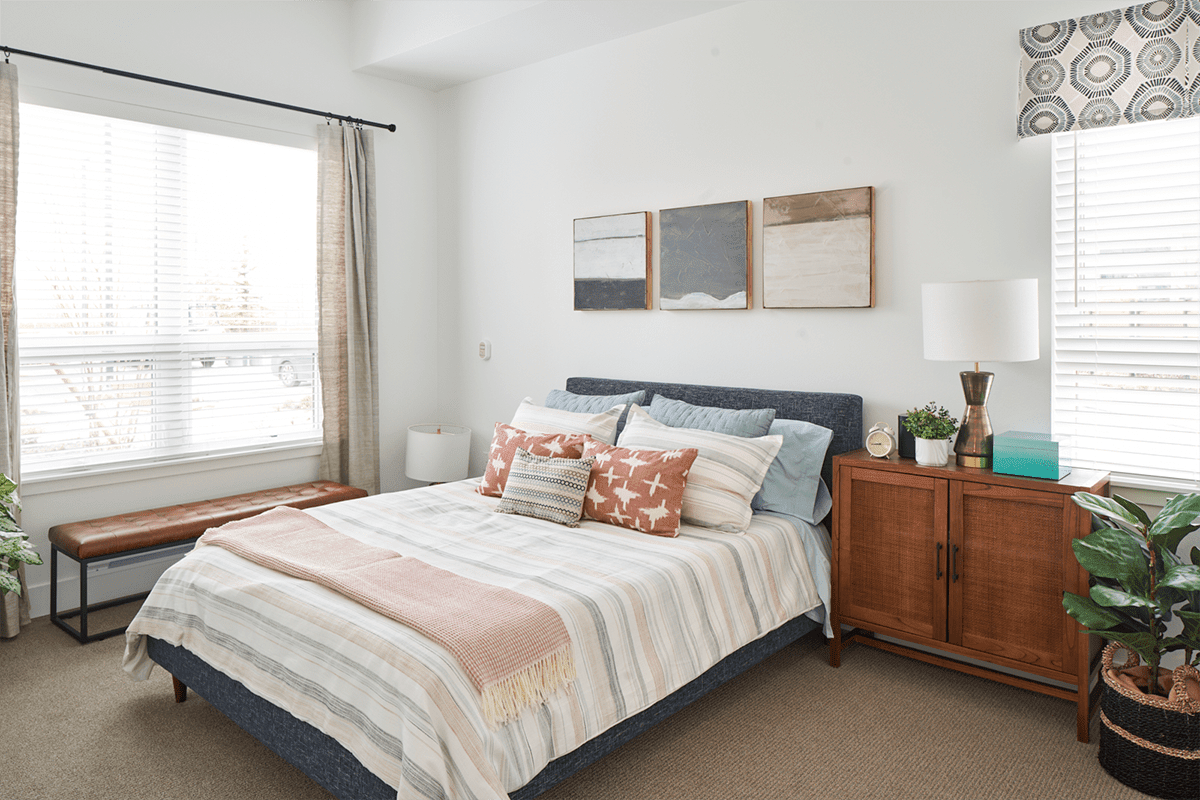 A modern bedroom with stylish decor and neutral tones.