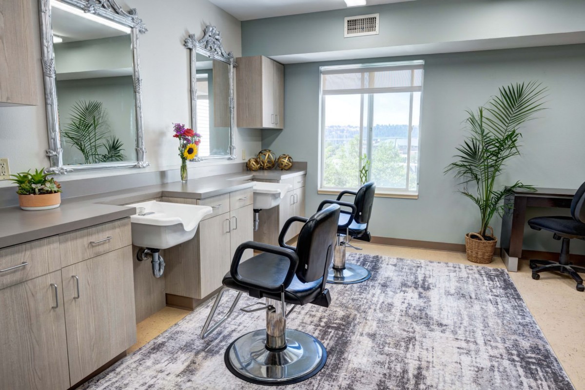 A modern hair salon interior with styling chairs and mirrors.