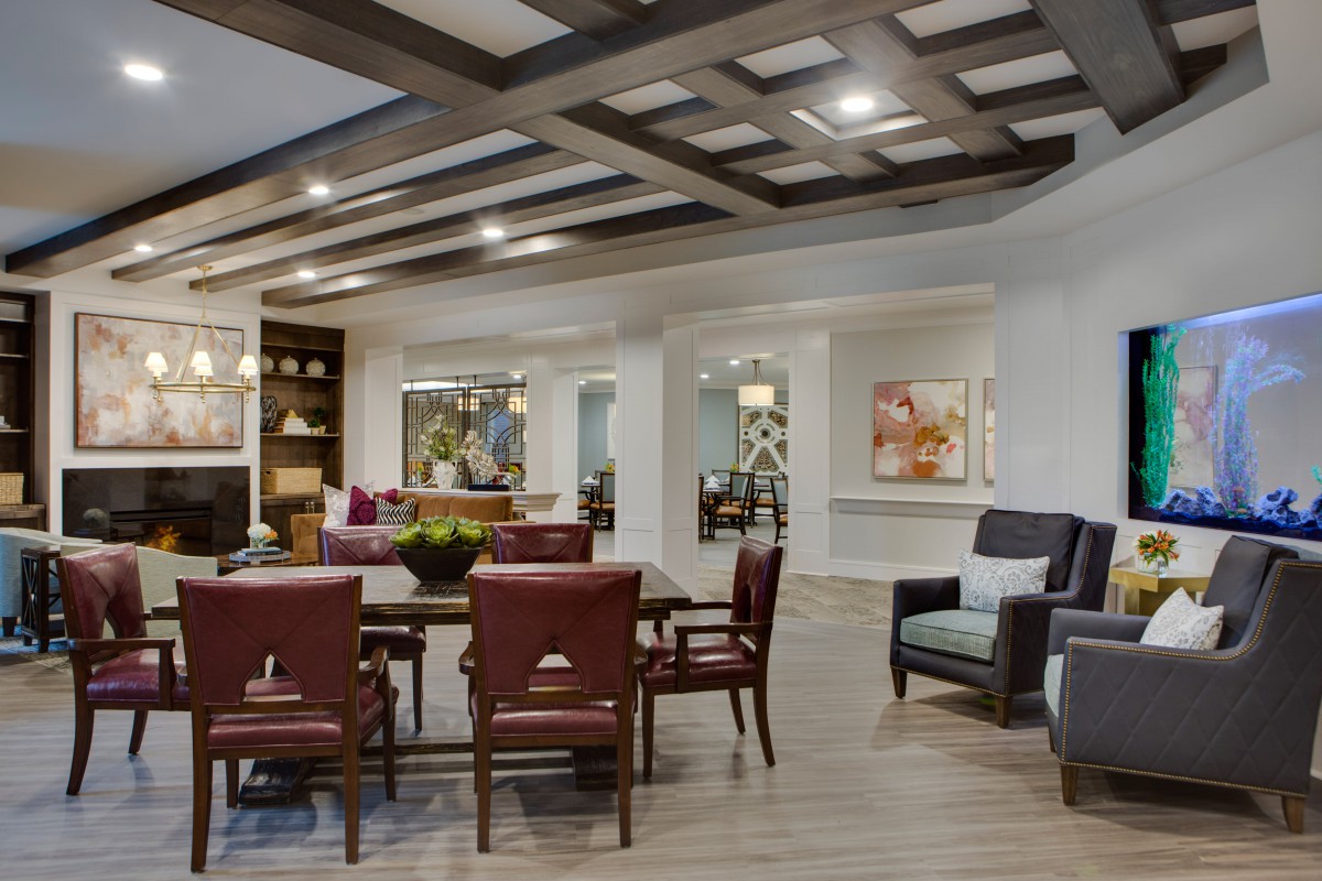 A modern living room with stylish furniture and a coffered ceiling.