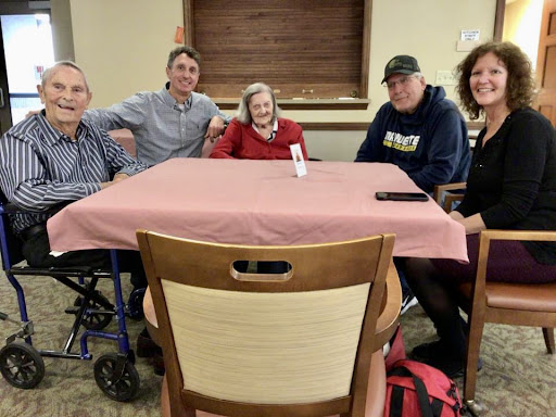 A joyful family gathering around the table, sharing moments together.