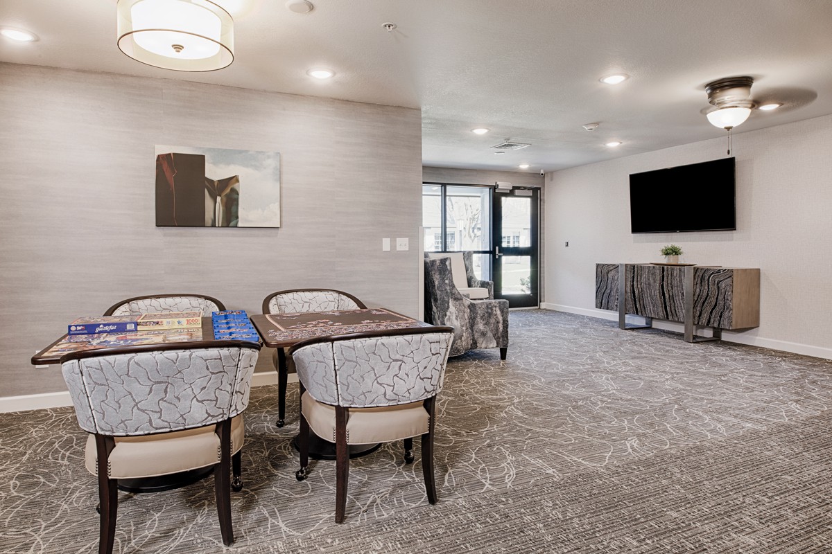 A modern living room with a seating area, television, and stylish decor.