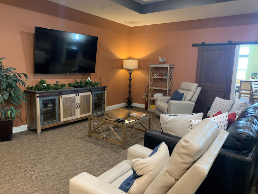 A cozy living room setup featuring comfortable seating and a mounted TV.