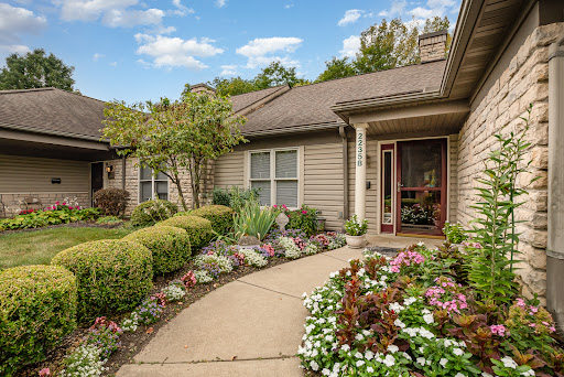 A charming residential home with a beautifully landscaped garden and colorful flowers.