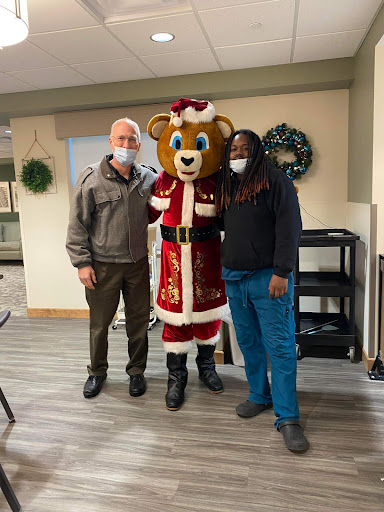 A festive gathering with a holiday mascot, celebrating the Christmas spirit.