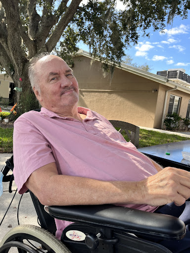 A cheerful man enjoying a sunny day outside.