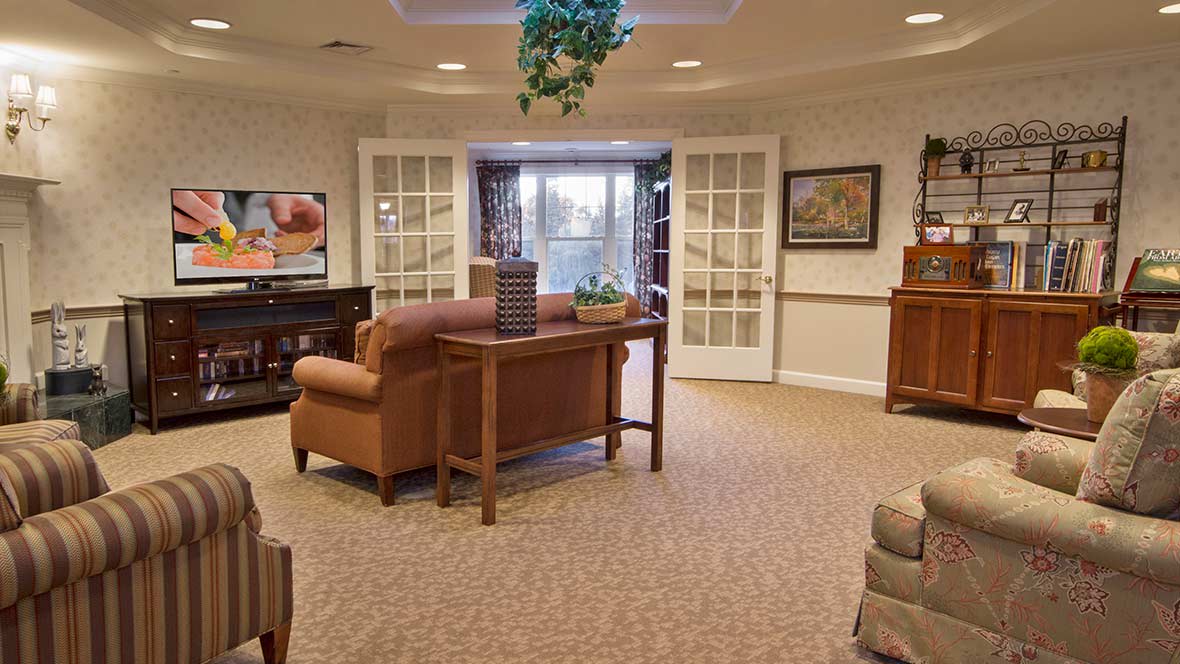 A cozy living room with comfortable furniture, artwork on the walls, and soft lighting.