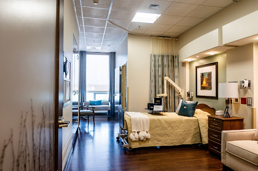 A well-lit and comfortable hospital patient room featuring modern furnishings.
