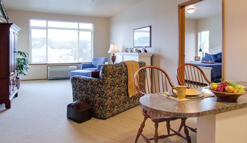 Cozy living room with a dining area and large window.