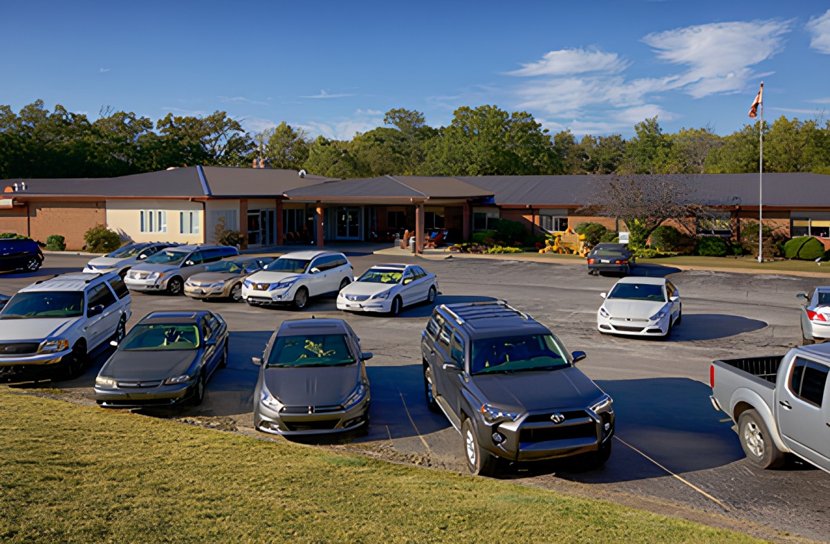 A parking lot in front of a building on a clear, sunny day.