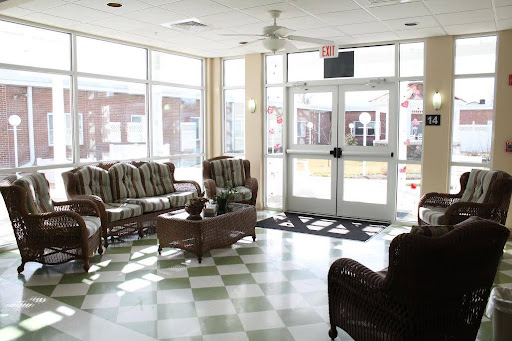 A bright and spacious lobby featuring comfortable seating and large windows.