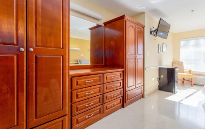 A wooden dresser and cabinet set in an interior space.
