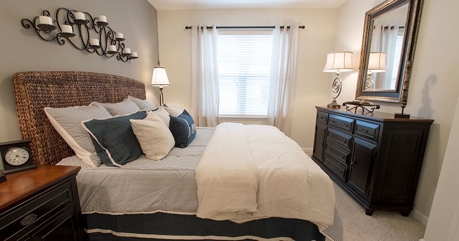 A cozy bedroom with elegant furnishings and soft lighting.