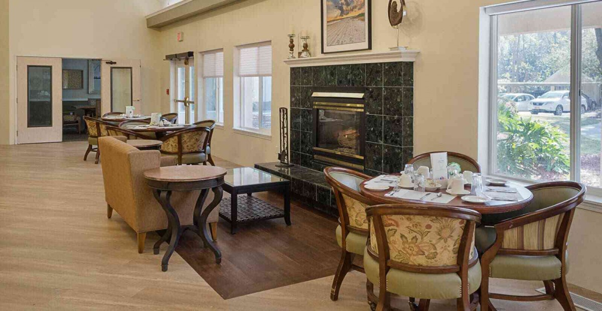 A cozy dining room with elegant furnishings and a fireplace.
