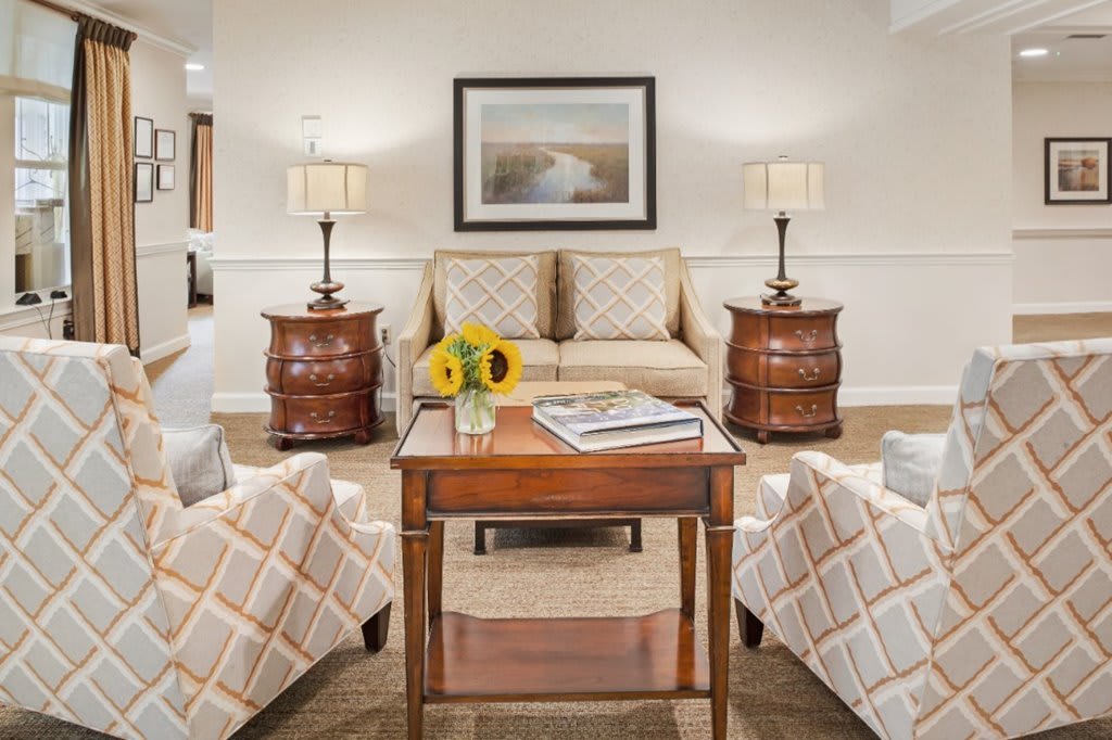 A cozy living room with matching furniture and elegant decor.