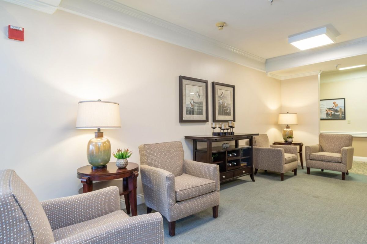 A well-furnished living room with comfortable chairs and stylish lamps.