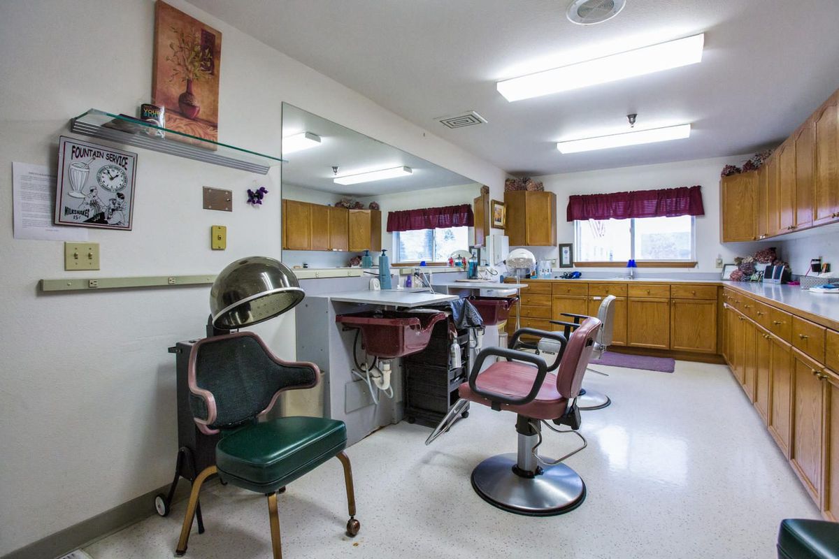 Interior of a classic barbershop with chairs, mirrors, and hair styling equipment.