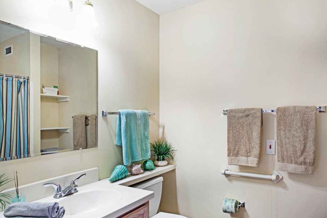 A tidy bathroom with colorful towels and modern decor.