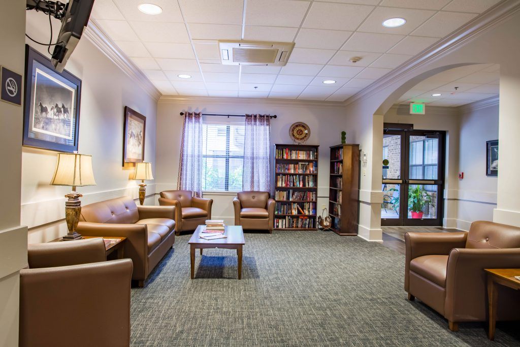 A cozy lobby area with comfortable seating and a bookshelf.