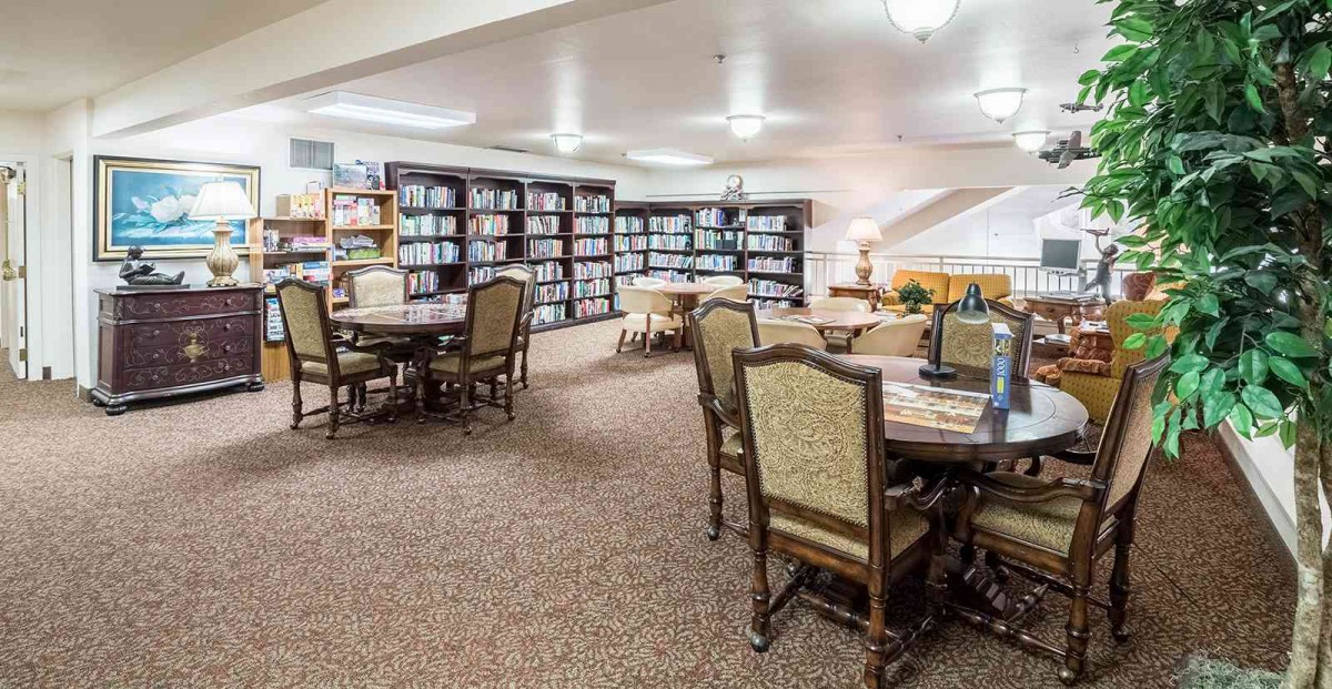 Cozy library with bookshelves and seating for reading.