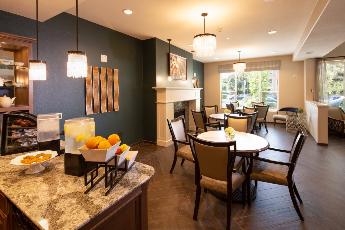 A modern, cozy dining area with elegant furniture and warm lighting.