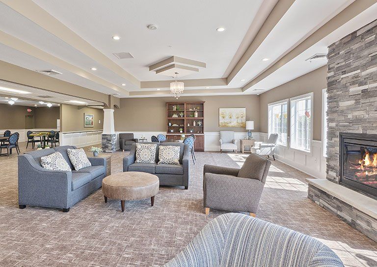 A spacious and well-lit living room with comfortable seating and elegant decor.