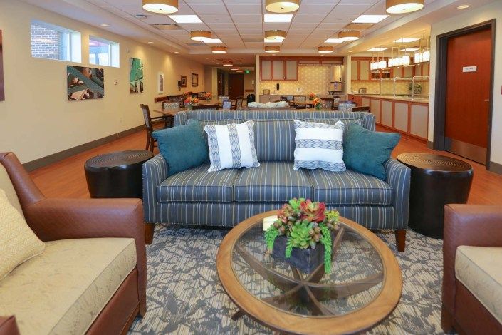 A spacious and well-decorated living room featuring a comfortable sofa, stylish coffee table, and tasteful decor.