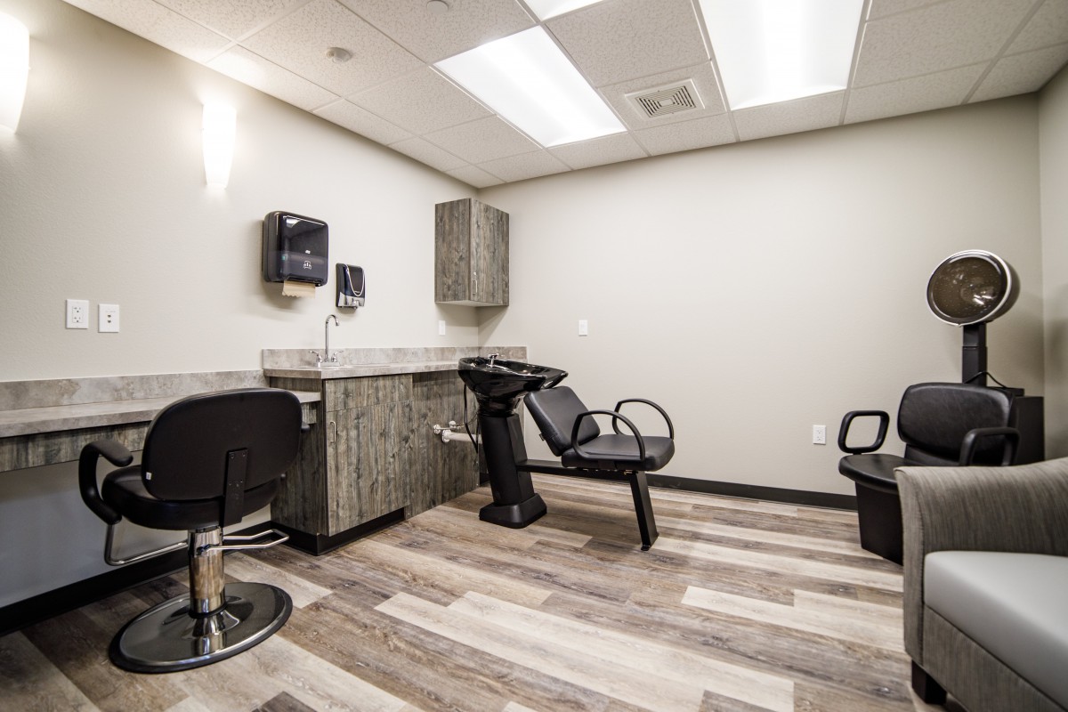 A modern hair salon interior with a hair washing station and chairs.