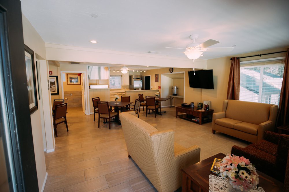 A cozy living room with comfortable seating, a mounted television, and elegant decor.