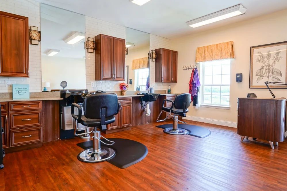 A bright and welcoming barbershop interior with styling chairs and mirrors.