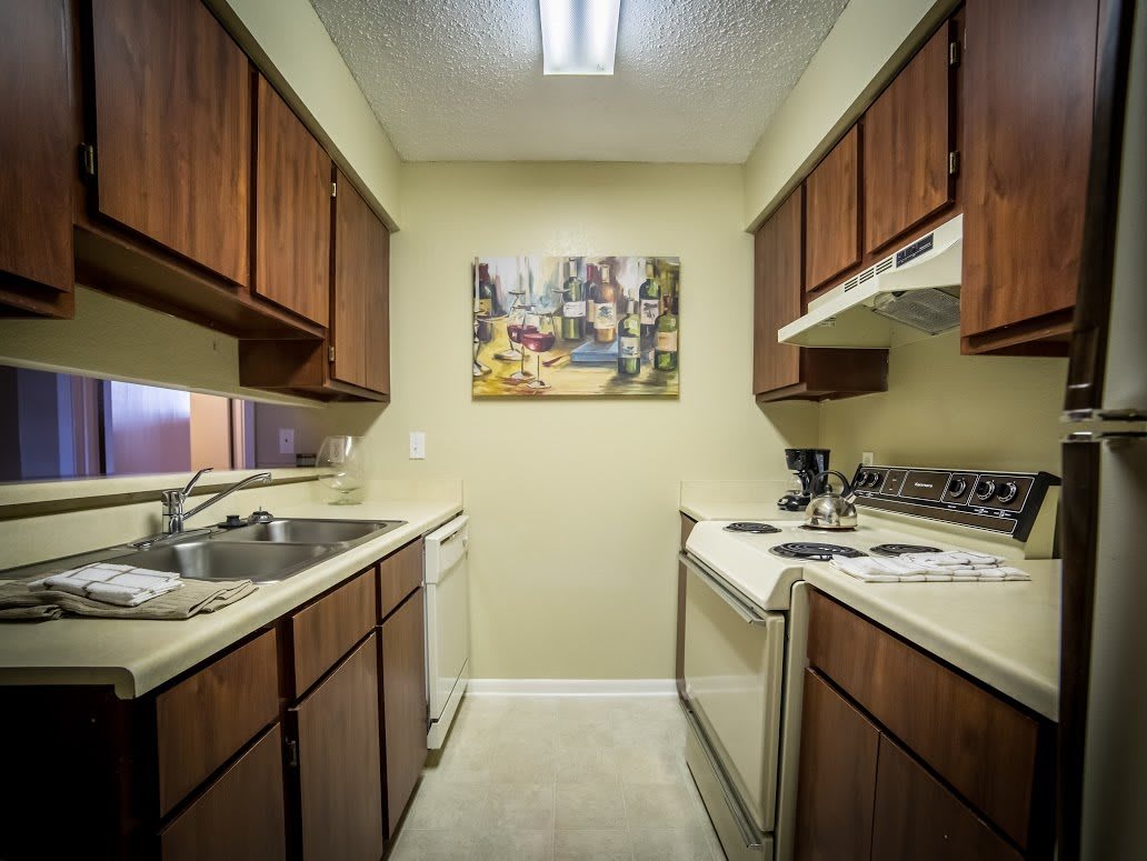 A compact kitchen with wooden cabinets and modern appliances.