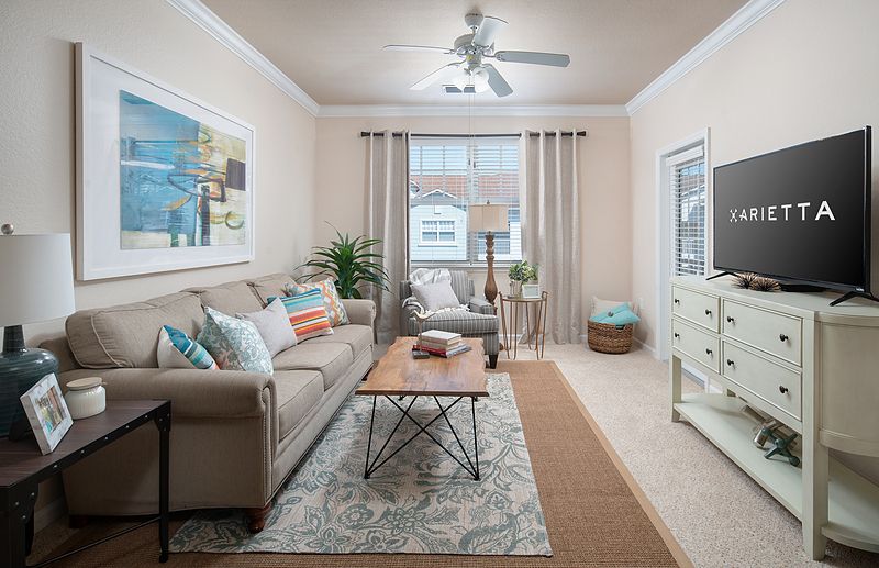 A cozy living room with a neutral color palette featuring a comfortable sofa, a wooden coffee table, and tasteful decor.